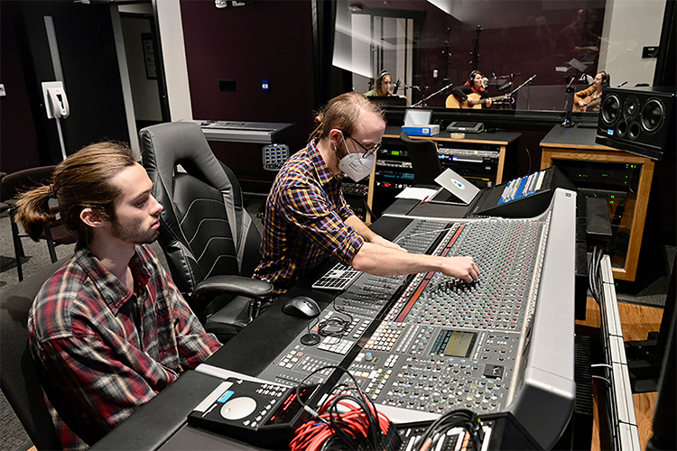 Fox DeVaughn, left, of Tupelo, Miss., a Master of Fine Arts in Recording Arts and Technologies student in Middle Tennessee State University's Department of Recording Industry, listens as fellow MFA student Nate Stoll of Portland, Oregon, checks the levels on a recording of student songwriters in the control room of the department's Studio E Friday night, Dec. 3. The students showcased their talents during the grand opening celebration for the university's new Main Street Studios, a nearly $2 million project that covers almost 5,000 square feet of recording space, control rooms and support space for the relocated Studios D and E. (MTSU photo by Andy Heidt)