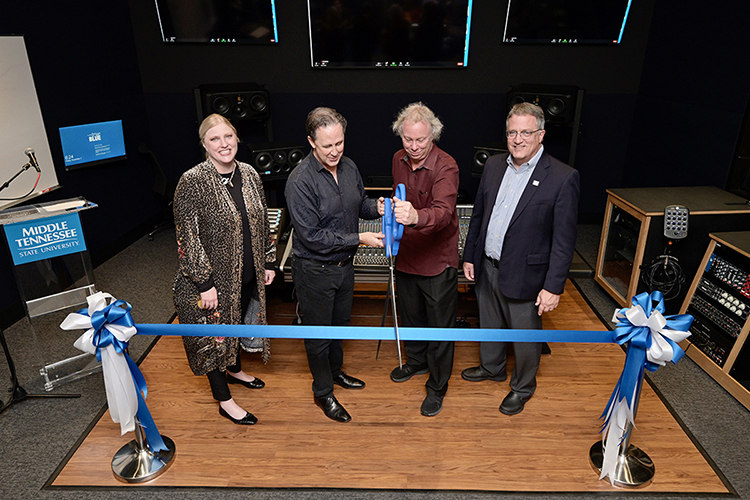 MTSU College of Media and Entertainment Dean Beverly Keel, left, and university Provost Mark Byrnes, right, smile as Department of Recording Industry chair John Merchant, center left, and audio production professor Dan Pfeifer cut a ceremonial ribbon Friday night, Dec. 3, in the control room of Studio D during a grand opening celebration for the new "Main Street Studios." The nearly $2 million project covers almost 5,000 square feet of recording space, control rooms and support space for the relocated Studios D and E. (MTSU photo by Andy Heidt)