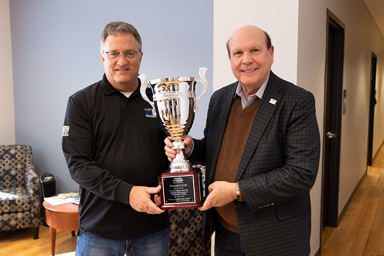 MTSU Provost Mark Byrnes, left, presents the Provost Cup to Jones College of Business Dean David Urban recently to wrap up the 2021-22 MTSU Employee Charitable Giving Campaign. The Provost Cup is a friendly competition between academic units that is awarded to the college with the highest percentage of employee participation. The Jones College of Business has won the cup for eight straight years. (MTSU photo by John Goodwin)