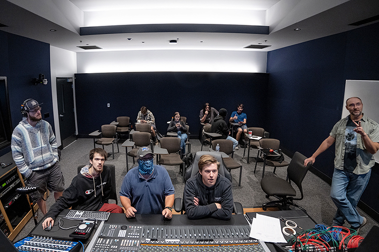 Students in the MTSU Department of Recording Industry Audio Production Program and the School of Music's Commercial Music Ensemble listen to playback of a recent "Studio Saturdays" recording session in Studio D in the brand-new Main Street Studios facility with their professors. From left in the front are audio production majors Samuel Roth, a senior from Farmington Hills, Mich., and junior Joseph Fernandez of Smyrna, Tenn.; adjunct audio engineering professor Eben Powell; Tanner Alguire, a junior audio production major from Cleveland, Tenn.; and adjunct music professor Matthew Lund. Seated at the back of the studio control room are, from left, Landon Cook, a junior audio production major from Little Rock, Ark.; and Commercial Music Ensemble members Maya Ronick, a freshman commercial songwriting major from Germantown, Md.; RJ Gick, a freshman, professional pilot and audio production double major from Lakeland, Tenn.; and Clay Skiles, a senior audio production and mathematical sciences double major from Cypress, Texas. Freshman Jacob Williams audio production major and CME member of Mt. Juliet, Tenn., has his back to the camera. (MTSU photo by Cat Curtis Murphy)