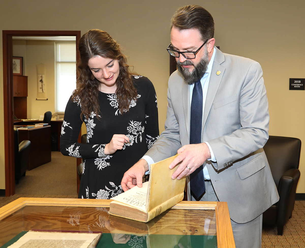 University Honors College Coordinator Tatum Hochstetler, left, and Associate Dean Philip Phillips scan one of more than 20 rare books on loan from The Remnant Trust at Texas Tech University. The books and manuscripts will be used by MTSU students in the spring Honors Lecture Series every Monday through April 4, with the exception of March 7. The books also will be on display for the public in Room 205 of the Paul W. Martin Sr. Honors Building from 8 a.m. to 4:30 p.m. daily. (MTSU photo by Marsha Powers)