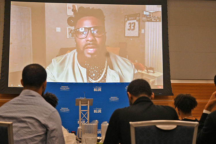 Participating on screen via Zoom, former NFL player Jay Barnett, an author, speaker, family therapist and mental health coach, addresses graduates of the latest Black Male Lecture Series by the Office of Student Success during the closing ceremony held Feb. 18 in the Student Union Ballroom. Barnett led the participating students through his K.I.N.G. program, which stands for Kindling Innovation Necessary for Growth. (MTSU photo by Jimmy Hart)