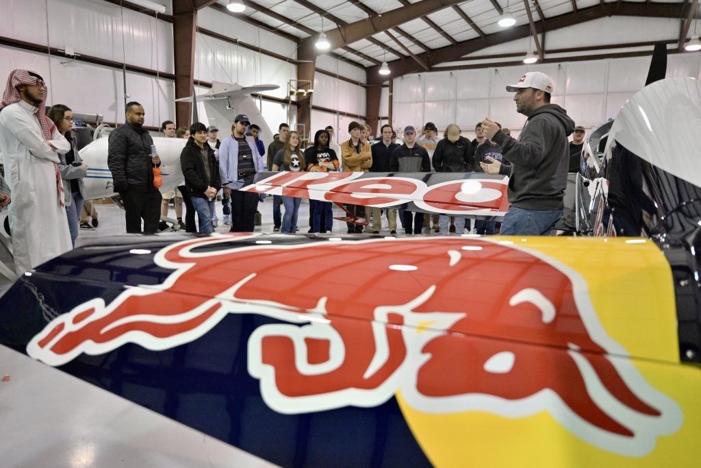 With the company’s airplane in the foreground, Kevin Coleman, Red Bull Air Race Challenger Class pilot, discusses the upcoming Paper Wings qualifying event and fields questions from MTSU students Tuesday, Feb. 22, at the Donald McDonald Hangar at aerospace’s Flight Operations Center at Murfreesboro Airport. All MTSU students are eligible to register for the Paper Wings event, to begin at 4 p.m. Wednesday, March 3. (Photo: Andy Heidt)