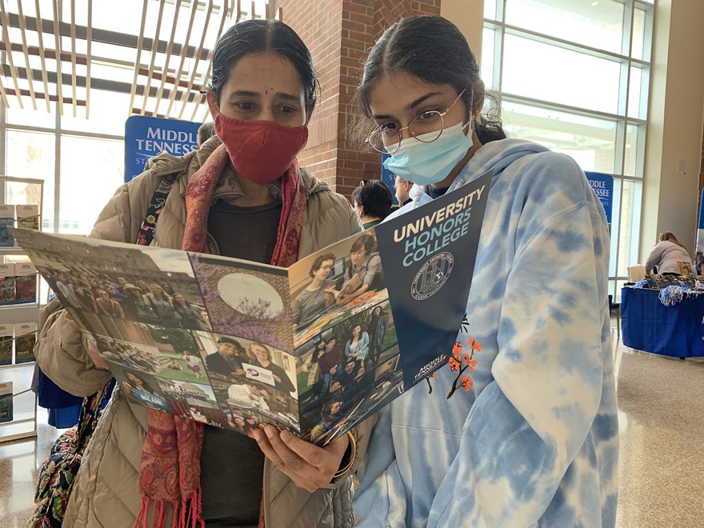 Aparna Arcot and her daughter, Ananya Arcot, of Brentwood, Tenn., browse through an Honors College brochure in the Student Union while visiting MTSU for the annual Presidents Day Open House and Celebration of Scholars Monday, Feb. 21. A Brentwood High School senior, Ananya Arcot said she is undecided on her major, but would like to be a part of the Honors College. (MTSU photo by James Cessna)