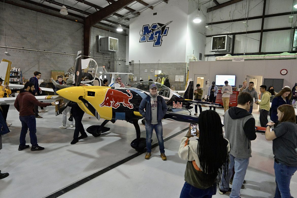 MTSU aerospace students take photos and check out the Red Bull competition plane, part of the company’s fleet, Tuesday, Feb. 22, in the Donald McDonald Hangar that’s part of the university’s Flight Operations Center at Murfreesboro Airport. All MTSU students can register to compete in the Red Bull Paper Wings qualifying event in the hangar starting at 4 p.m. Wednesday, March 3. (MTSU photo by Andy Heidt)