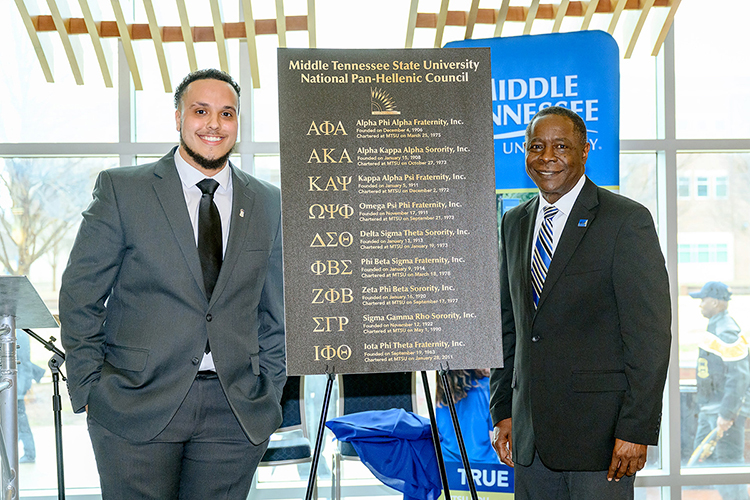 Jalen Everett, left, MTSU president of the National Pan-Hellenic Council, and MTSU President Sidney A. McPhee pose with a prototype of the bronze plaque honoring the NPHC's "Divine 9" organizations and the council’s 50-year relationship with the university. The council represents nationally recognized historically Black fraternities and sororities. The omnibus plaque and plaques for each of the individual organizations are located in the Student Union Commons and were dedicated Feb. 17 during a ceremony in the Student Union. (MTSU photo by J. Intintoli)