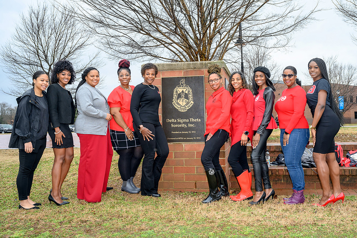 Members of Delta Sigma Theta Sorority Inc. pose beside a plaque honoring their organization on the Student Union Commons following a Feb. 17 dedication ceremony inside the Student Union. (MTSU photo by J. Intintoli)