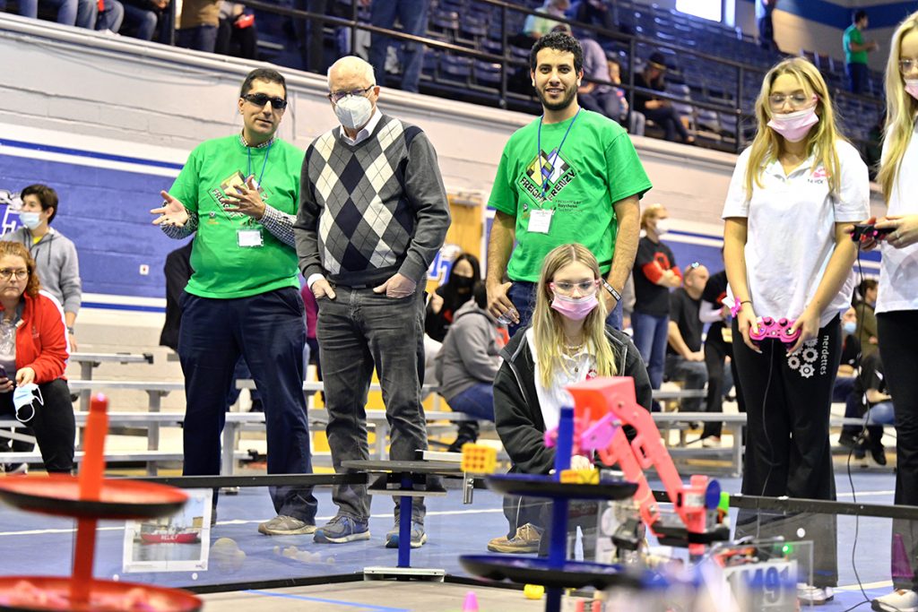 MTSU mechatronics engineering faculty member Tony Saavedra, left, Engineering Technology Chair Ken Currie and mechatronics student Antonious Hanna watch as members of the Nerdettes FTC team from Owens Cross Roads, Ala., compete in the recent Tennessee FIRST Tech Challenge robotics event in Alumni Memorial Gym. The Nerdettes earned the Connect Award bestowed by judges. (MTSU photo by Cat Curtis Murphy)