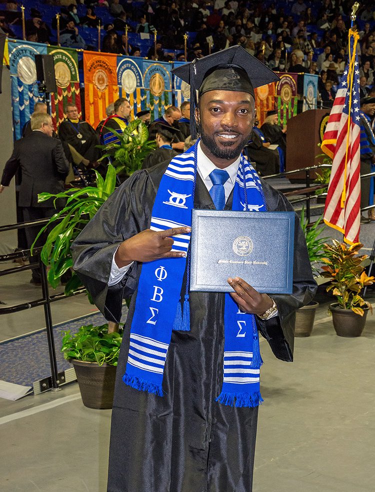 MTSU recording industry alumnus Terrance McGarr celebrates earning his degree after walking the stage at Murphy Center during the December 2021 commencement ceremony. (MTSU photo by Flash Photography)