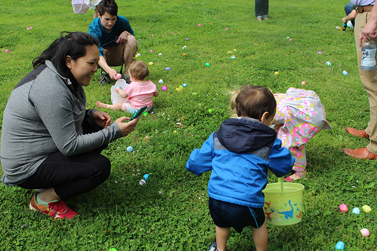 Family members help their children gather eggs at the 2019 Easter Egg Hunt hosted by the MTSU Panhellenic Council on the lawn of the President’s House. The 2020 hunt was canceled due to the COVID pandemic, and the 2021 hunt was a drive-thru event. The 2022 event returns to an in-person format on April 10. (Photo submitted)