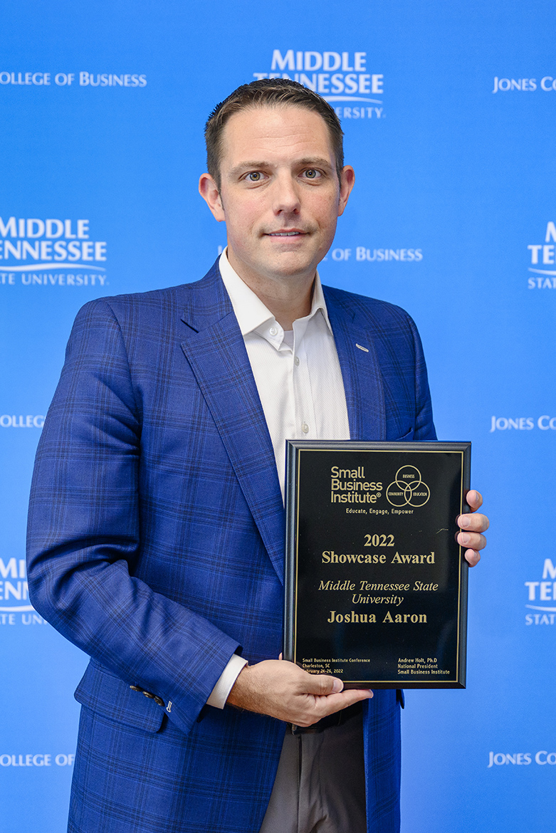 MTSU management professor Joshua Aaron, Pam Wright Chair of Entrepreneurship in the Jennings A. Jones College of Business, holds the Small Business Institute’s 2022 “Showcase Award” inside the Business and Aerospace Building. Aaron accepted the award, signifying the top entrepreneurship program of the year within the professional development organization, at the annual SBI national conference in Charleston, South Carolina, in late February. (MTSU photo by J. Intintoli)