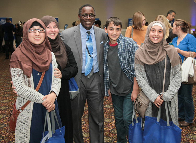 MTSU President Sidney A. McPhee, third from left, meets, from left, Fatimah, Khadijah, Ahmed and Zaynab Alnassari in 2019 during the True Blue Tour event in Nashville at the Millennium Maxwell House Hotel. Khaeijah Alnassari's children are triplets. All four of the Alnassaris are MTSU students. (MTSU photo by John Goodwin)