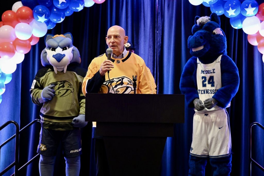 Flanked by Nashville Predators’ mascot Gnash, left, and MTSU’s Lightning, retired U.S. Army Lt. Gen. Keith M. Huber addresses a pregame crowd attending the Predators’ Military Appreciation Night featuring the university’s Daniels Veterans Center. “The Predators demonstrate the success of teamwork, controlled aggressive actions and continuous tenacity when facing adversity,” Huber said. “They’re predators, like we are when we need to be, to hunt out evil people who would attempt to steal our freedoms, harm our democracy and punish our families.” (MTSU photo by James Cessna)