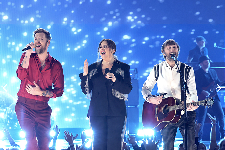 Former MTSU student Hillary Scott, center, Charles Kelley and Dave Haywood of Lady A perform "What A Song Can Do" onstage during the 57th Academy of Country Music Awards at Allegiant Stadium March 7 in Las Vegas. (photo by Kevin Winter/Getty Images for ACM)