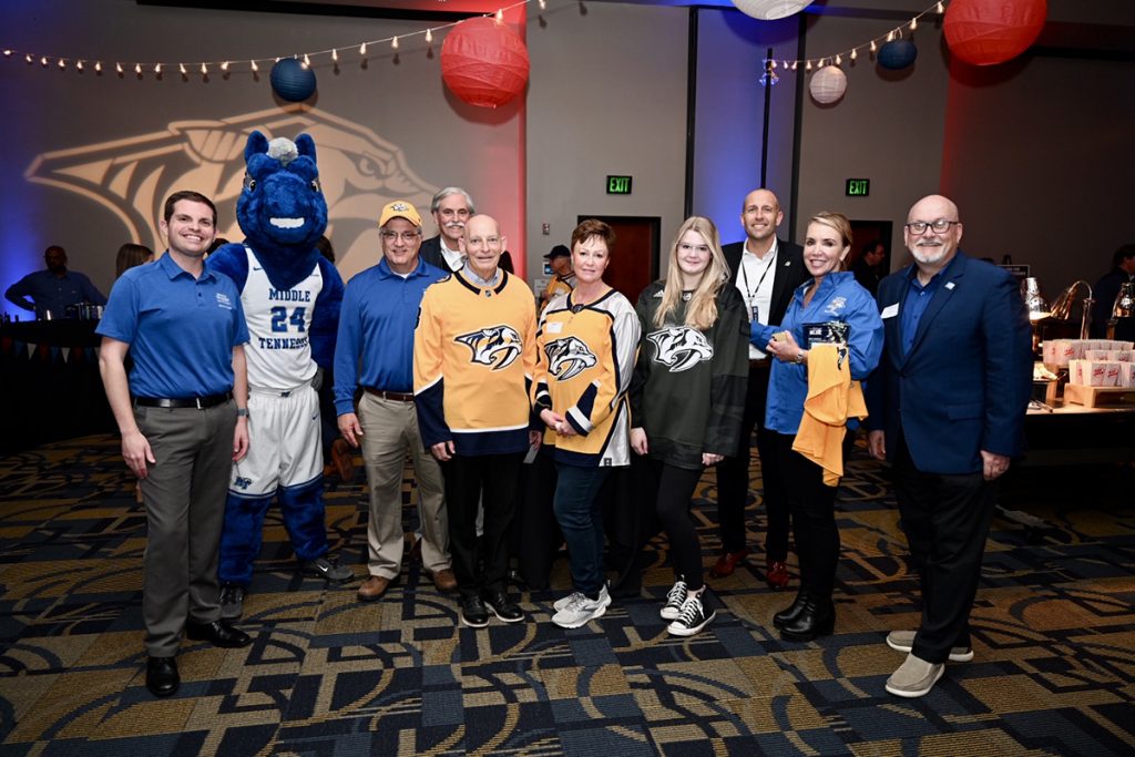 MTSU students, administrators and others with university ties attended the Nashville Predators-Dallas Stars game Tuesday, March 8, in Bridgestone Arena. Attendees included National Alumni Association President Matthew Hibdon, left, mascot Lightning, Provost Mark Byrnes, Ed Arning, retired U.S. Army Lt. Gen. Keith M. Huber, Shelly Huber, Alexis Huber, the Predators’ Jason Oxford, Daniels Center Director Hilary Miller and Andrew Oppmann, vice president of Marketing and Communications. Keith Huber is senior adviser for veterans and leadership initiatives at MTSU. Oxford is director of corporate development for the NHL club. (MTSU photo by James Cessna)