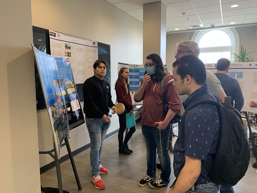 MTSU Department of Physics and Astronomy students and faculty attend the first-ever posters exhibit in Wiser-Patten Science Hall March 17. Faculty and administrators shared about the growth in research for the small but growing program. (MTSU photo by Randy Weiler)