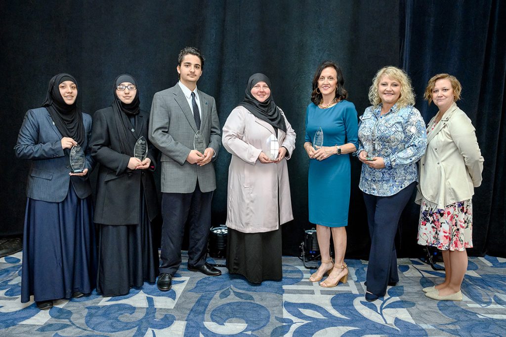 The winners of the 2022 Trailblazer Awards pose with their statuettes at the conclusion of MTSU's National Women's History Month Closing Ceremony March 29 at the Ingram Building. From left, MTSU students and Future Trailblazer winners Zaynab Alnassari, Fatimah Alnassari, Ahmad Alnassari, and Khadijah Alnassari; Trailblazer winners Lucy Langworthy, advisor to the dean of the College of Liberal Arts, and Terri Schultz, executive director of Habitat for Humanity of Rutherford County; and Maigan Wipfli, chair of the MTSU NWHM Committee and director of the June Anderson Center for Women and Nontraditional Students. (MTSU photo by J. Intintoli)