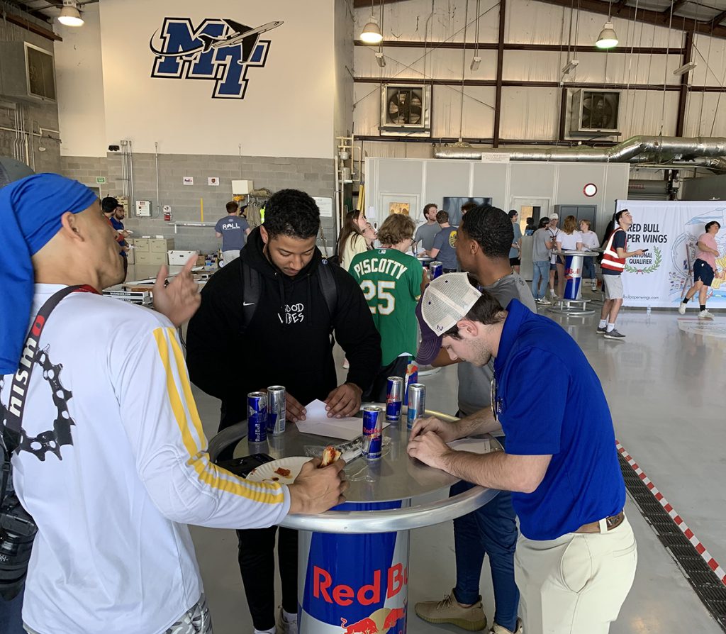 Red Bull Paper Wings MTSU student participants make their plans and enjoy the food and drinks provided Thursday, March 3, at the Donald McDonald Hangar, part of the MTSU Department of Aerospace Flight Operations Center at Murfreesboro Airport. The hangar was alive with students making paper planes for the Paper Wings local qualifier. Senior David Parrott (distance) and sophomore Abanoub Hanna (air time) winning and earn berths at the regional April 16 in Huntsville, Ala. (MTSU photo by Randy Weiler)