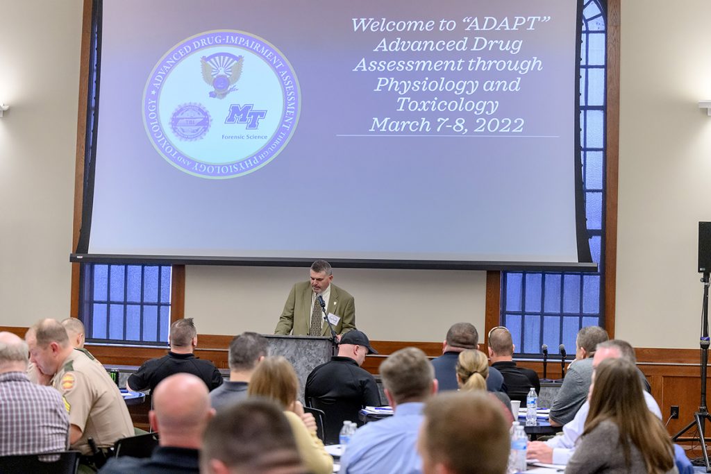 Tony Burnett, Tennessee DRE coordinator, introduces MTSU biology assistant professor Kiel Ormerod and welcomes the crowd of 100 state, local and county officers attending the two-day “ADAPT” workshop March 7-8 in the MTSU Ingram Building’s MT Center. MTSU Forensic Science teamed with the TBI and Tennessee Highway Safety Office for session. (MTSU photo by J. Intintoli)