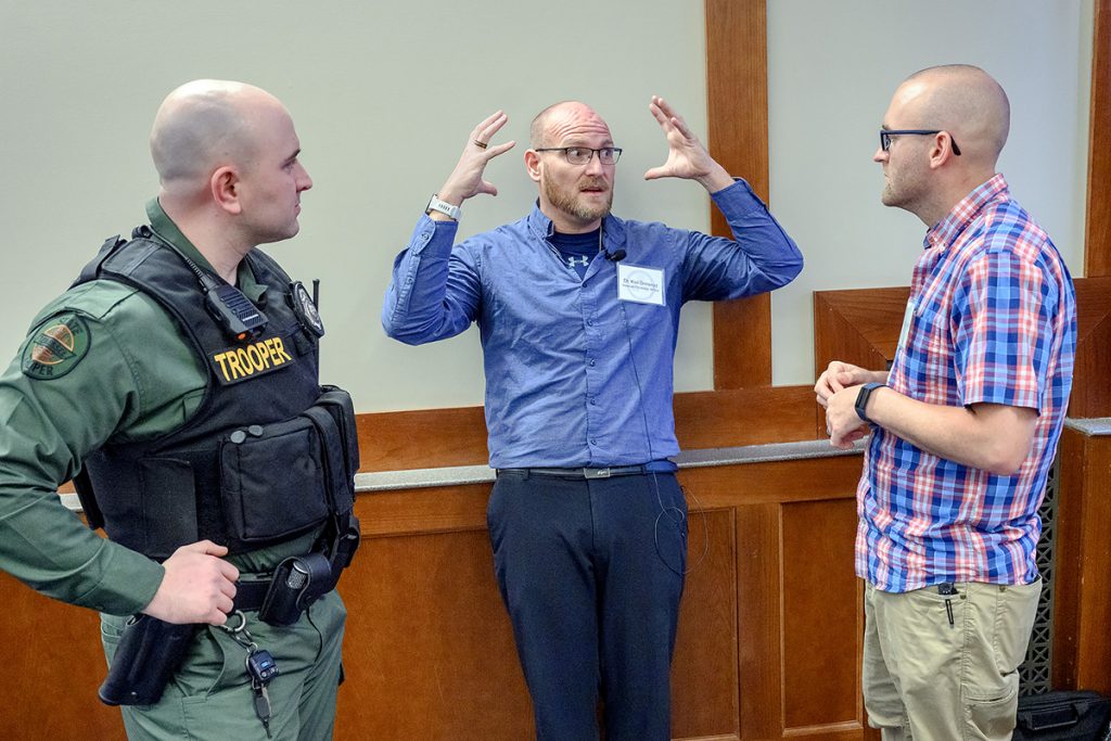 Tennessee Highway Patrol Trooper Dylan Culver, left, Cookeville and Arend Groeneweg, right, with the Metro Nashville Police Department listen as MTSU biology assistant professor Kiel Ormerod answers Groeneweg's question during a break in the MTSU Forensic Science/THP/ Tennessee Highway Safety Office ADAPT lecture on the brain for an audience of law enforcement officials in the Ingram Building's MT Center. It was one of several presentations for the drug recognition experts, or DREs, on March 7. (MTSU photo by J. Intintoli)