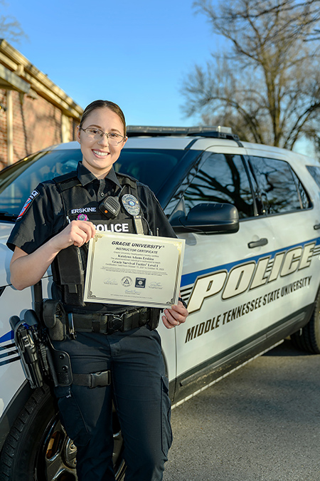 Middle Tennessee State University Police Officer Katelynn Erskine displays her recently earned certification to serve as a Defensive Tactics Instructor — the first female officer in the department to do so — outside of the campus police department on Feb. 28, 2022. (MTSU photo by J. Intintoli)