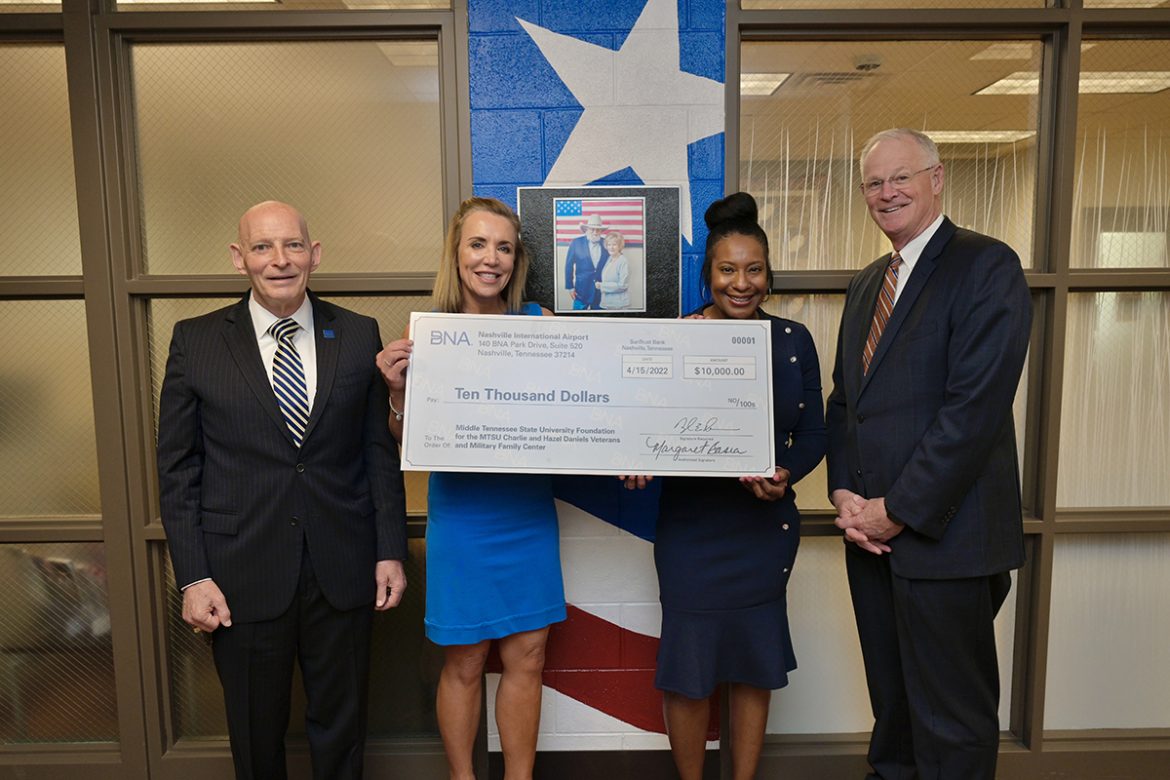 MTSU's Keith M. Huber and Hilary Miller, left, with the Charlie and Hazel Daniels Veterans and Military Family Center, accept a $10,000 donation Friday, April 15, from the Metro Nashville Airport Authority, and delivered by BNA's Stacey Nickens and Doug Kreulen to the Daniel's Center. (MTSU photo by Andy Heidt)