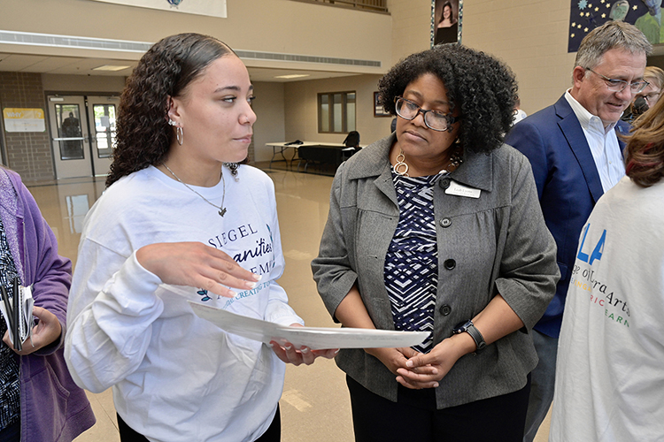 Jaxyn Luscinski, a Siegel High School junior, explains her Siegel Humanities Academy project to Leah Lyons, dean of the MTSU College of Liberal Arts. The academy, a collaboration between the high school and the university, celebrated the conclusion of its first semester in an April 26 ceremony at the high school. (MTSU photo by Andy Heidt)
