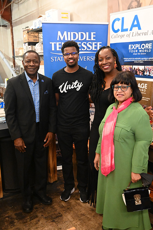 2003 graduates Ceylon Wise and Ashley Brooks Wise, who created an educational YouTube channel with their young sons and are part of the best children’s music album-nominated compilation, “All One Tribe,” with MTSU President Sidney A. McPhee. (MTSU Photo by Andrew Oppmann)