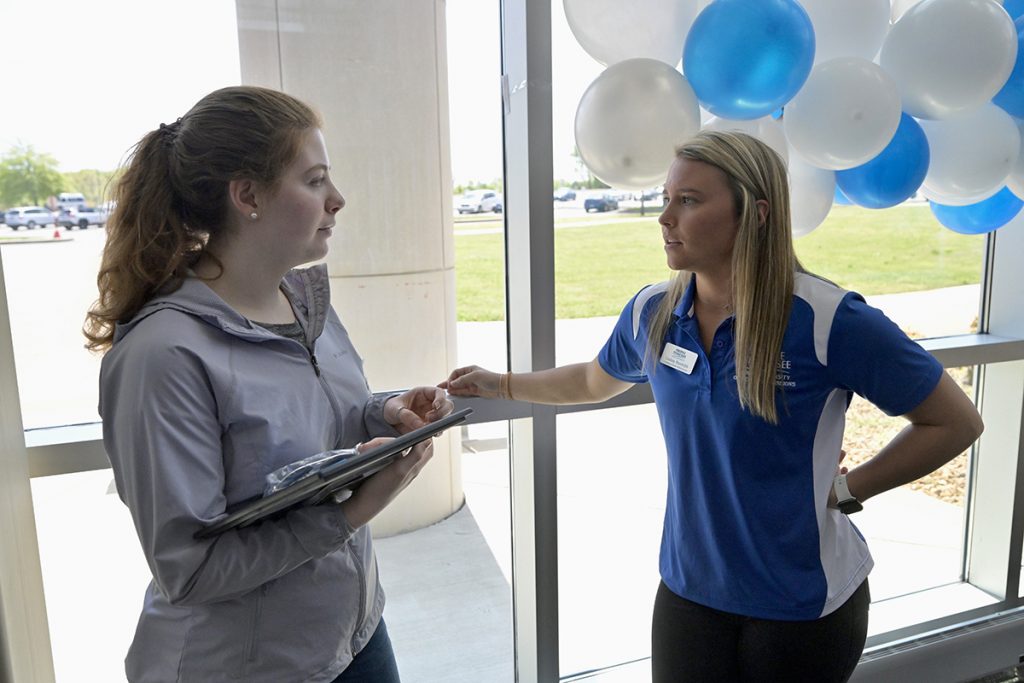 La Vergne High School senior Ella Coffey, left, talks with MTSU Admissions recruiter Lindsey Randolph, learning more about opportunities at the university. One of La Vergne's valedictorians, Coffey plans to study education and become a teacher. She and 16 other seniors received certificates from MTSU, where all plan to attend starting in August. (MTSU photo by Andy Heidt)