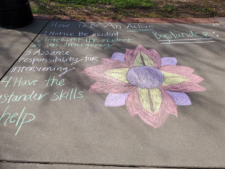 A sidewalk square decorated for the 2021 "Color the Commons" event tells people what to do if they witness an act of sexual assault. The 2022 "Color the Commons" is scheduled for Wednesday, April 20. (Photo submitted)