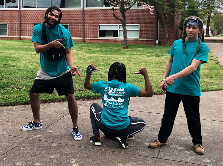 Three students show their support for the 2021 "Walk a Mile in Their Shoes," a Sexual Assault Awareness Month event at MTSU. The 2022 event is slated for Tuesday, April 12. (Photo submitted)
