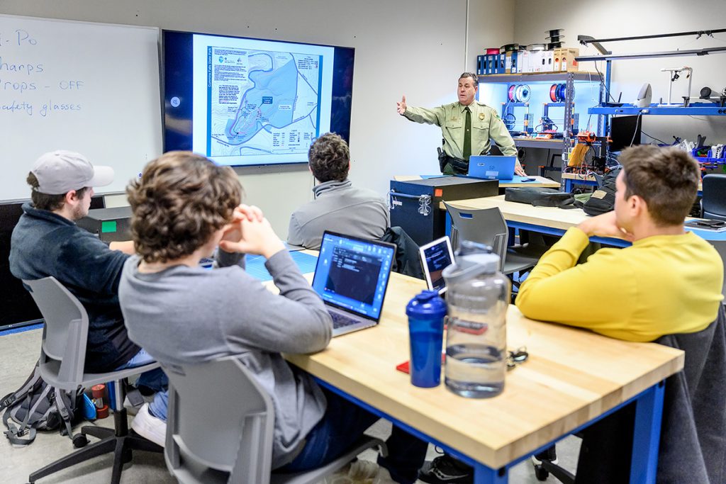 Shane Petty, chief ranger for Tennessee State Parks since 1997, talks to professor Kevin Corns' unmanned aircraft students in the BAS UAS lab about their involvement in a potential mission for a presumed missing person at Cummins Falls State Park earlier this year. The students traveled to the park in Jackson County near Cookeville, Tenn., April 1 to map conclusions in the case. (MTSU photo by J. Intintoli)