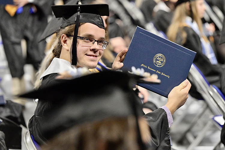 A graduating senior at Middle Tennessee State University holds his new degree with pride during the university's fall 2021 commencement ceremonies last December. The university will award degrees to more than 2,475 members of the first Class of 2022 on Saturday, May 7, during three ceremonies at its spring 2022 commencement event inside Murphy Center. (MTSU file photo by Andy Heidt)