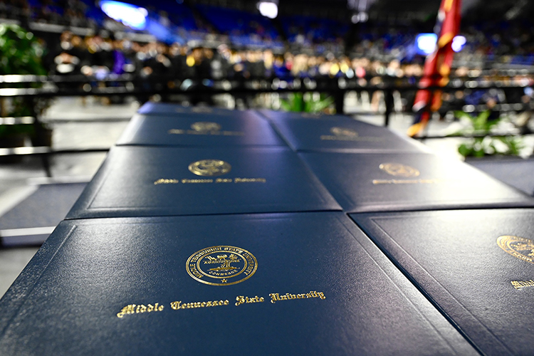 New diploma covers are stacked neatly on the stage in Middle Tennessee State University's Murphy Center, waiting to be presented to the last members of the Class of 2021 during fall 2021 commencement ceremonies last December. The university will award degrees to more than 2,475 members of the first Class of 2022 on Saturday, May 7, during three ceremonies at its spring 2022 commencement event inside Murphy Center. (MTSU file photo by J. Intintoli)