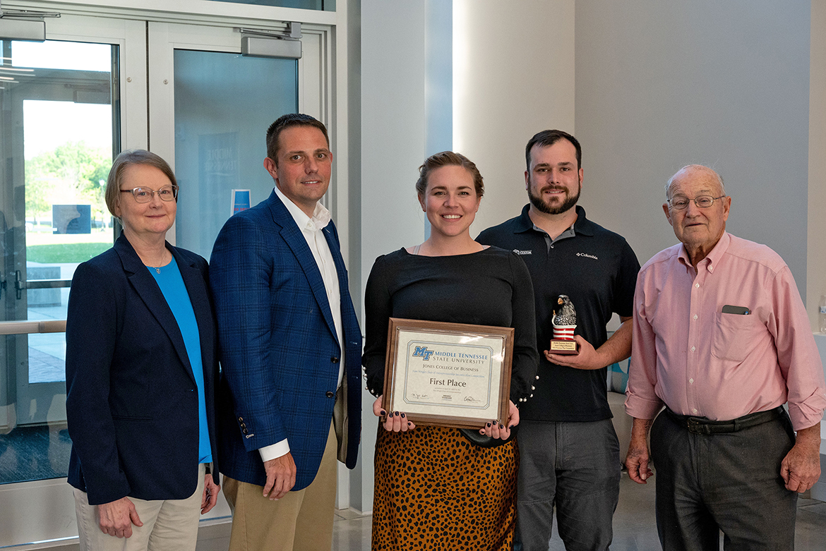 MTSU graduate student Jessie Buntin and her husband, Jacob, third and fourth from left, are presented the first-place plaque and $8,000 prize at the conclusion of the 2022 Business Plan Competition Finals presented by the Pam Wright Chair of Entrepreneurship within the Department of Management. Pictured, from left, are Jill Austin, Department of Management chair; Joshua Aaron, management professor and Wright Chair of Entrepreneurship; the Buntins; and donor and judge Wil Clouse, who also presented the Buntins with the Robert and Virgie Clouse Spirit Award and $600 prize. The Buntins won the overall first place award for their proposal for their custom cabinetry business, Buntin Custom LLC. The finals were held April 27 in the Academic Classroom Building. (MTSU photo by Darby Campbell-Firkus)