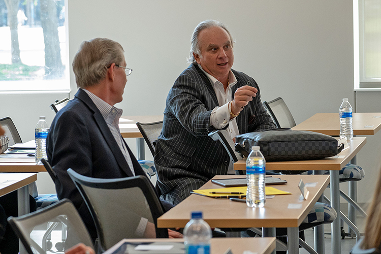 MTSU alumnus Chuck McDowell, right, asks a question during the 2022 Business Plan Competition Finals held April 27 in the Academic Classroom Building. McDowell, founder and CEO of Wesley Financial Group LLC, is a long-time donor and competition judge for the Jones College of Business event. Looking on at left is fellow competition judge John Dilenschneider. (MTSU photo by Darby Campbell-Firkus)