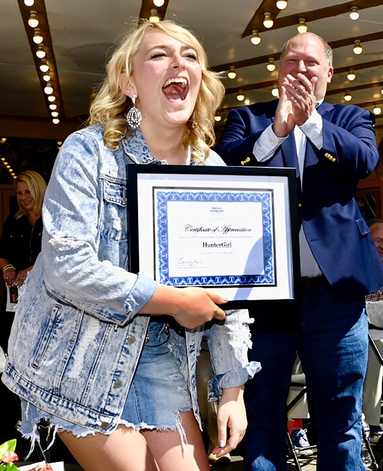 MTSU alumna and ‘American Idol’ finalist Hunter ‘HunterGirl’ Wolkonowski is elated after receiving an honorary professorship from her alma mater Tuesday, May 17, during a celebration of her Idol success outside the Oldham Theatre located on the public square of her hometown of Winchester, Tenn. In the background is MTSU associate professor of songwriting Odie Blackmon, who taught Wolkonowski in 2019. (MTSU photo by J. Intintoli)