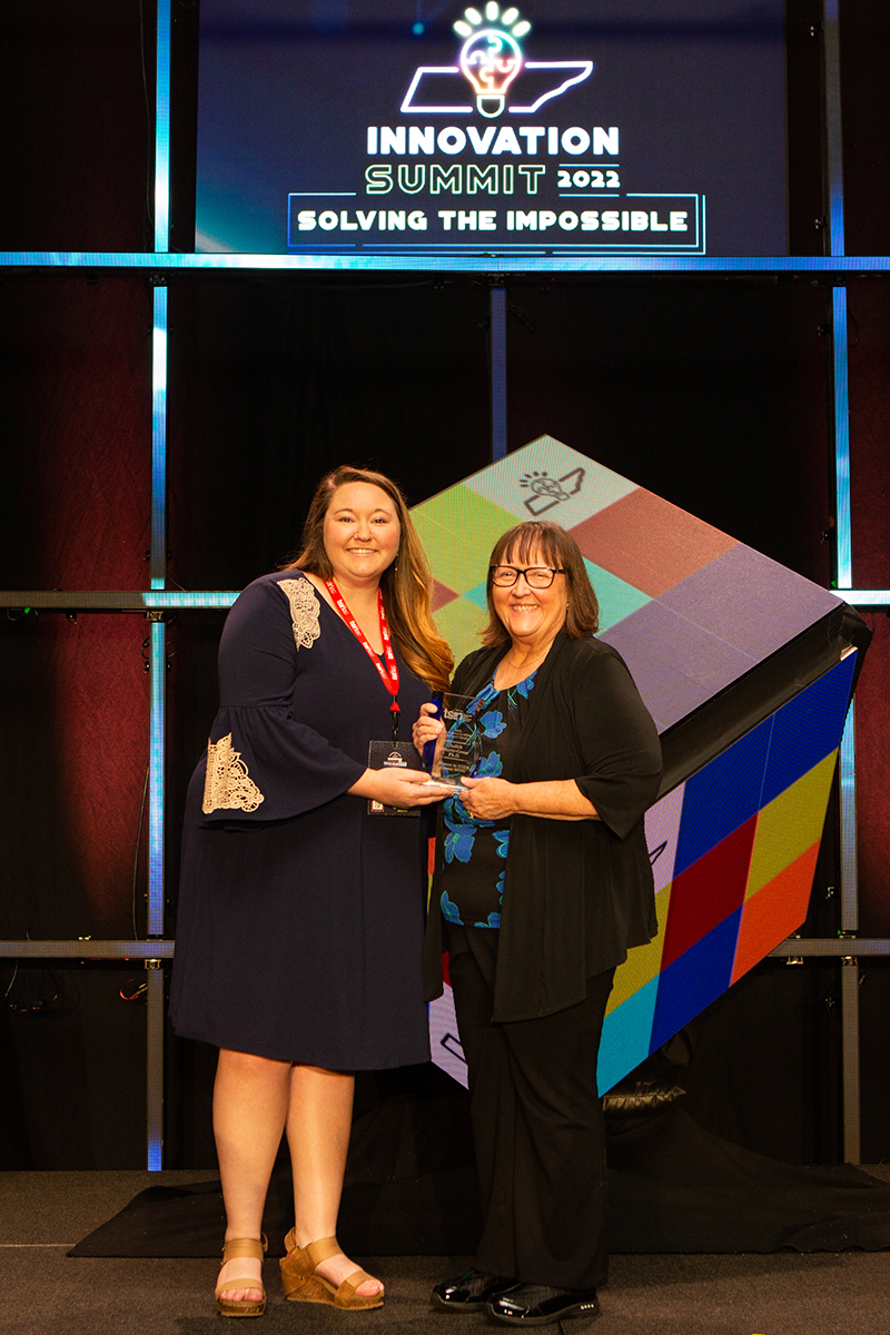 Kristin McQueen, left, a relationship manager with the Tennessee STEM Innovation Network, congratulates MTSU WISTEM Center Director Judith Iriarte-Gross for earning the 2022 TSIN Excellence in Advocacy Award Tuesday, May 10, at the Music City Center in Nashville, Tenn. An MTSU faculty member since 1996, Iriarte-Gross has been recognized for many awards throughout her career. (Tennessee STEM Innovation Network photo by Tina Gionis)
