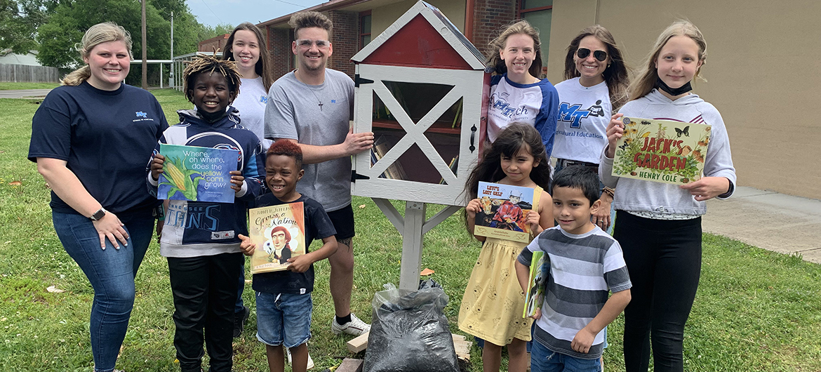 Reeves-Rogers Elementary School students, front row from left, Charlie Savannah, Kourtland Windrow, Aurora Bereuben, Jose Lopez and Abigail Bruckheimer hold agriculture-related books placed in the new Little Free Library built by MTSU agricultural education students. The MTSU students, who also are Collegiate FFA members, include, back row from left, Savannah Scott, Angayla Maxwell, Colby Chapman, Lily Steed and Morgan Maynard. (MTSU photo by Randy Weiler)