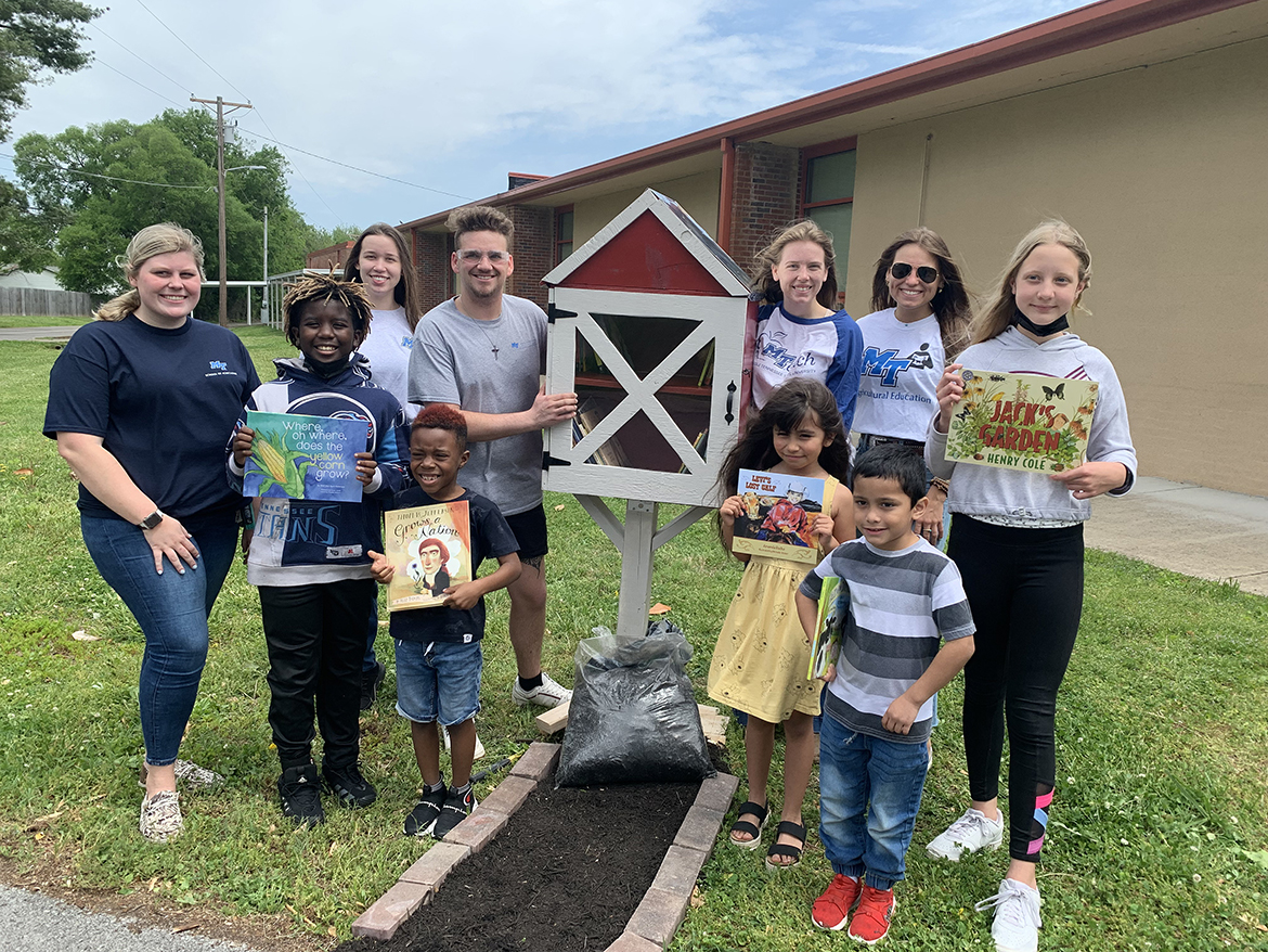 Reeves-Rogers Elementary School students, front row from left, Charlie Savannah, Kourtland Windrow, Aurora Bereuben, Jose Lopez and Abigail Bruckheimer hold agriculture-related books placed in the new Little Free Library built by MTSU agricultural education students. The MTSU students, who also are Collegiate FFA members, include, back row from left, Savannah Scott, Angayla Maxwell, Colby Chapman, Lily Steed and Morgan Maynard. (MTSU photo by Randy Weiler)