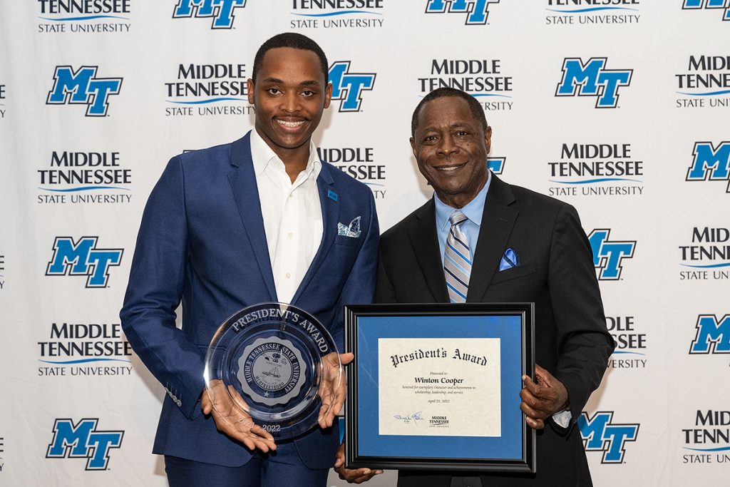 MTSU SGA President Winton Cooper, left, receives the 2021-22 MTSU President's Award from university President Sidney A. McPhee recently during an awards banquet in the Student Union Ballroom. Cooper and McPhee are Bahama natives. (MTSU photo by Cat Curtis Murphy)