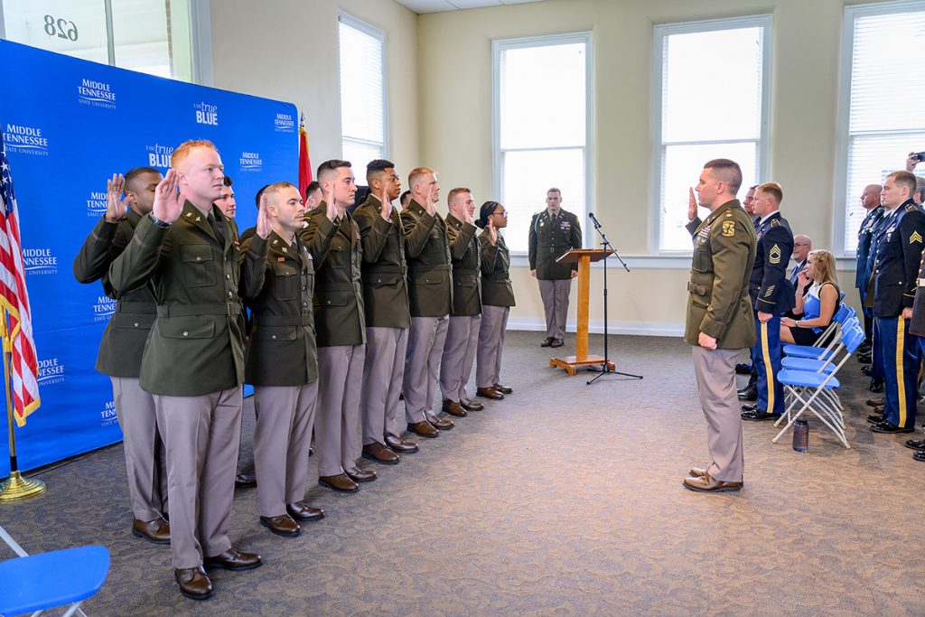 MTSU Military Science Department Chair and U.S. Army Maj. Ben Sweeney, right, administers the Commissioning Oath to 13 ROTC cadets as they received their commissioning Friday, May 6, during the MTSU Blue Raider Battalion spring commissioning ceremony in the Tom H. Jackson Building’s Cantrell Hall. (MTSU photo by J. Intintoli)