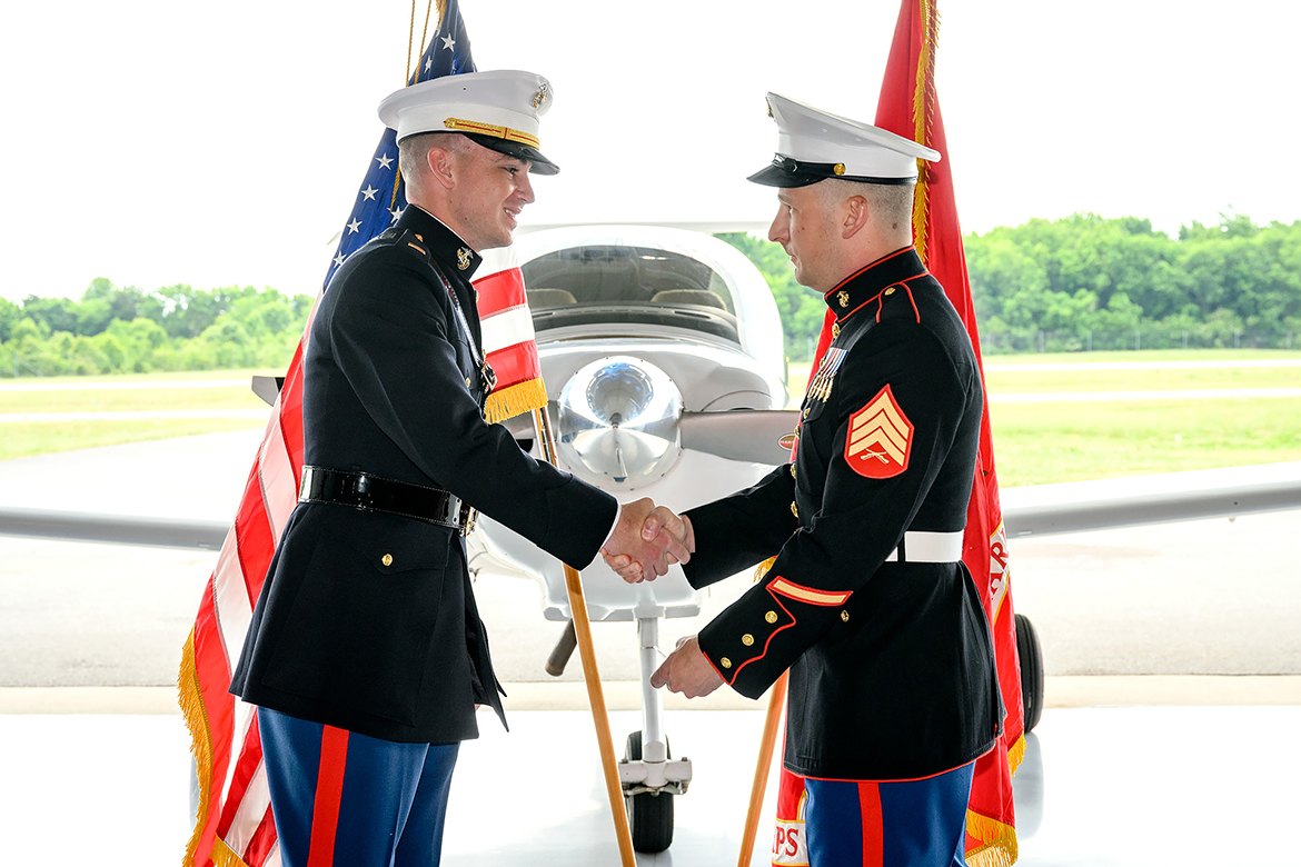Recent MTSU graduate Isaac Wehner, left, receives his first salute as a newly commissioned second lieutenant in the U.S. Marine Corps from Sgt. Jason Pickard, a friend and fellow alumnus, May 20 at the Donald McDonald Hangar at MTSU’s Flight Operations Center at Murfreesboro Airport. Both graduated from the MTSU aerospace program’s pro pilot concentration. (MTSU photo by J. Intintoli)