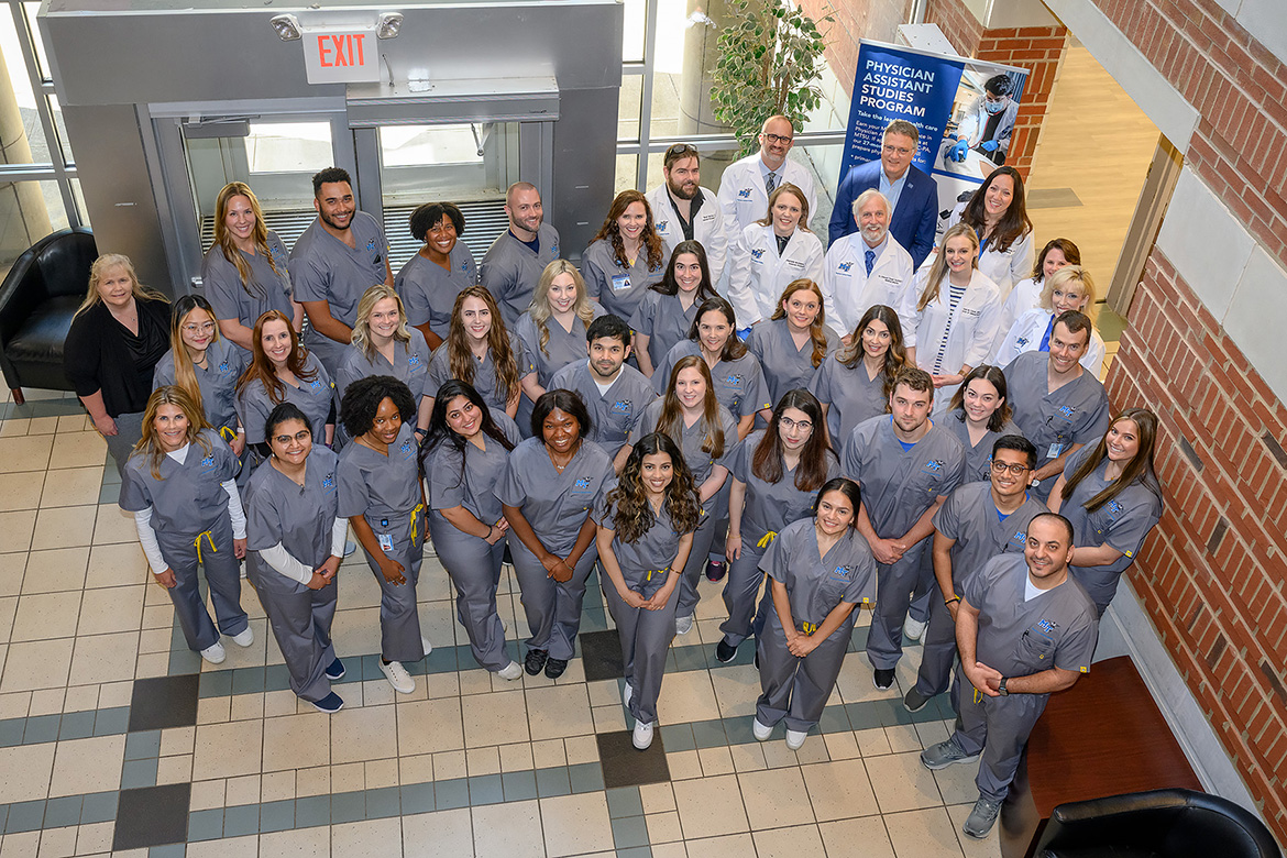 The first cohort of Middle Tennessee State University’s new Physician Assistant Studies graduate program of 30 students attends its grand opening event in their gray scrubs at the Cason Kennedy Nursing Building on campus on May 13, 2022. (MTSU photo by J Intintoli)