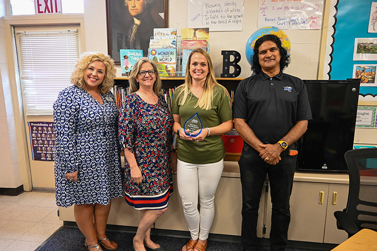 Fourth grade teacher Ashlee Barnes at Hobgood Elementary School, third from left, received the Mentor Teacher of Excellence Award from Middle Tennessee State University’s College of Education on April 25, 2022, at her classroom in Murfreesboro, Tenn. Pictured, from left, are MTSU associate education professors Shannon Harmon and Angela Hooser, Barnes and associate education professor Zaf Khan. (MTSU photo by Stephanie Barrette)