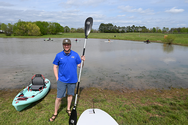 Blake Osborn, Middle Tennessee State University outdoor pursuits coordinator, supervises students out on kayaks and paddleboards — equipment purchased as part of a $70,000 grant from the Tennessee Wildlife Resource Agency to fund the university’s new fishing program — on April 14, 2022, by the pond at the Rutherford County Agriculture Center in Murfreesboro, Tenn. (MTSU photo by Stephanie Barrette)