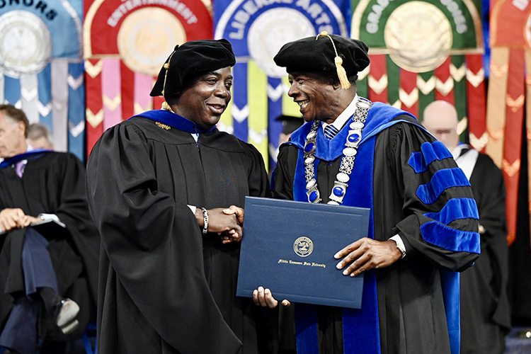 Prime Minister Philip Edward Davis of the Bahamas, left, thanks Middle Tennessee State University President Sidney A. McPhee Saturday, May 7, after Davis received an honorary MTSU doctorate during the university's spring 2022 morning commencement ceremony in Hale/Earle Arena inside Murphy Center. Davis was also the event's guest speaker. MTSU awarded 2,474 degrees — 2,041 to undergraduates and 433 to graduate students — during its three-ceremony spring 2022 commencement event. (MTSU photo by James Cessna)