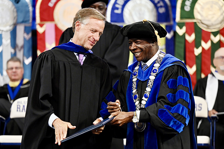 Former Tennessee Gov. Bill Haslam, left, listens to Middle Tennessee State University President Sidney A. McPhee Saturday, May 7, after Haslam received an honorary MTSU doctorate during the university's spring 2022 morning commencement ceremony in Hale/Earle Arena inside Murphy Center. MTSU awarded 2,474 degrees — 2,041 to undergraduates and 433 to graduate students — during its three-ceremony spring 2022 commencement event. (MTSU photo by James Cessna)