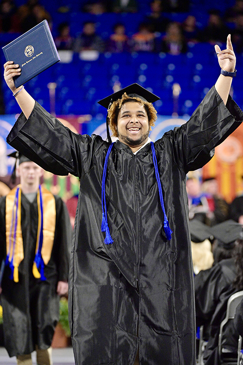 A Middle Tennessee State University graduate celebrates his hard-won accomplishment in Murphy Center after accepting his new degree Saturday, May 7, during the university's spring 2022 afternoon commencement ceremony. MTSU awarded 2,474 degrees — 2,041 to undergraduates and 433 to graduate students — during its three-ceremony spring 2022 commencement event. (MTSU photo by Andy Heidt)