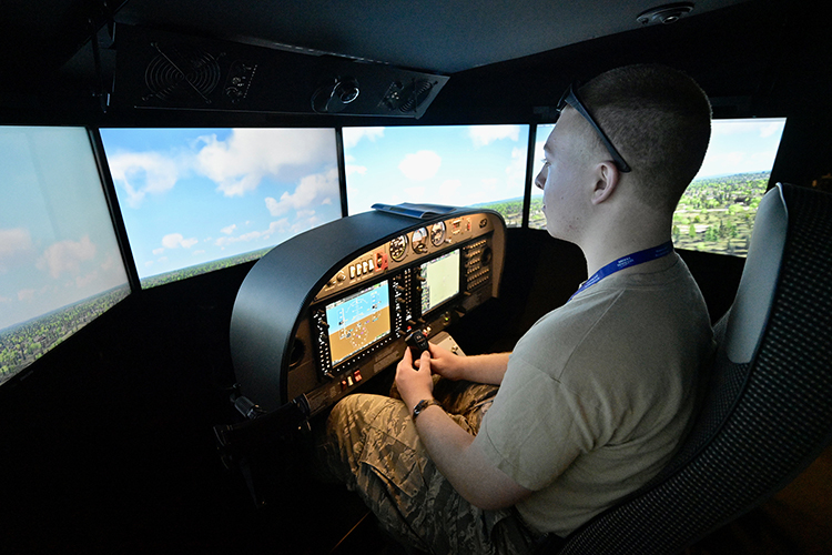 A Civil Air Patrol cadet tries out an MTSU Aerospace Department flight simulator Monday, June 27, at Murfreesboro Airport. The university is hosting about 40 selected cadets for the U.S. Air Force volunteer civilian auxiliary’s National Cadet Engineering Technology Academy, also known as E-Tech, which started June 26 and through July 2 on the campus. (MTSU photo by Andy Heidt)